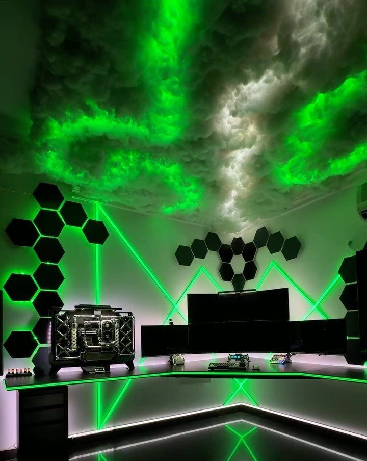 Gaming setup with green LED lighting, hexagonal wall panels, and a glowing cloud ceiling.