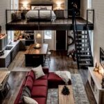 Small home interior with a loft bedroom overlooking a living room and kitchen.