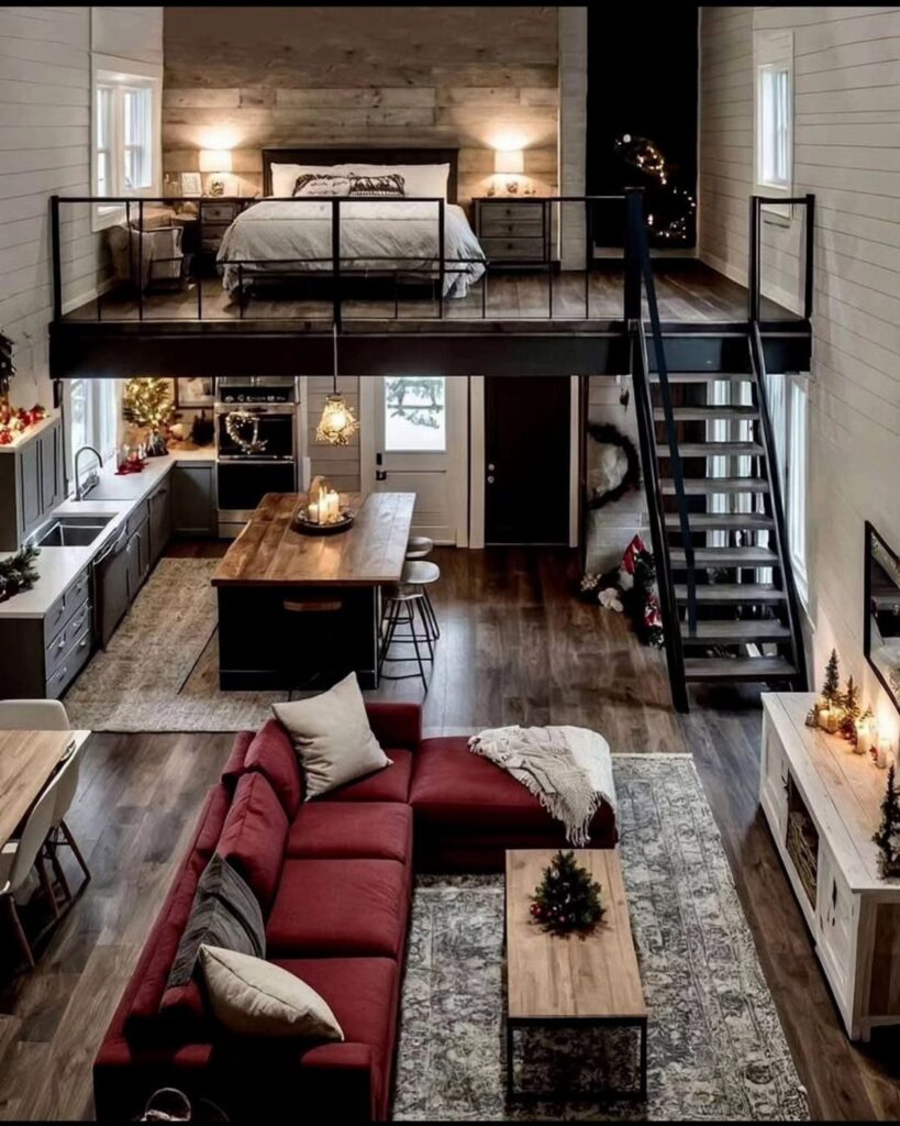 Small home interior with a loft bedroom overlooking a living room and kitchen.