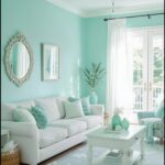 Bright living room with light turquoise walls, white furniture, and a blue rug.