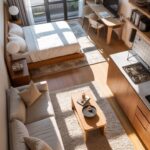 Studio apartment layout with integrated bedroom, living area, workspace, and small kitchen.